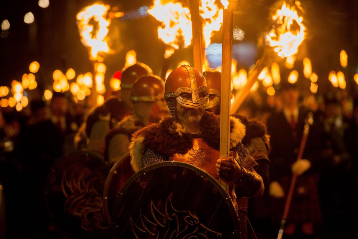Vikings from Shetland's Up Helly Aa Festival take part in a torchlight procession which marks the start of Edinburgh's Hogmanay festival. Around 20,000 people, including 17,000 torchbearers, took part in the procession down the Royal Mile, past Holyrood Palace and the Scottish Parliament: PA