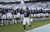 North Carolina's Michael Carter (8) leads the celebration following the Tar Heels' 56-49 victory over Virginia Tech in an NCAA college football game, Saturday, Oct. 10, 2020 at Kenan Stadium in Chapel Hill, N.C. (Robert Willett/The News & Observer via AP)