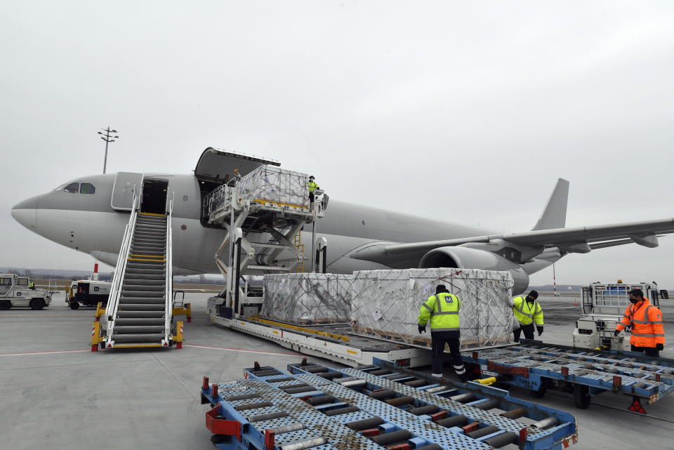 Boxes containing vaccines are unloaded from a Hungarian Airbus 330 cargo plane as the first batch of the vaccine against the new coronavirus produced by Sinopharm of China arrives at Budapest Liszt Ferenc International Airport in Budapest, Hungary, Tuesday, Feb. 16, 2021. The vaccine will not be used without its examination and approval by the National Public Health Center of Hungary. (Zoltan Mathe/MTI via AP)