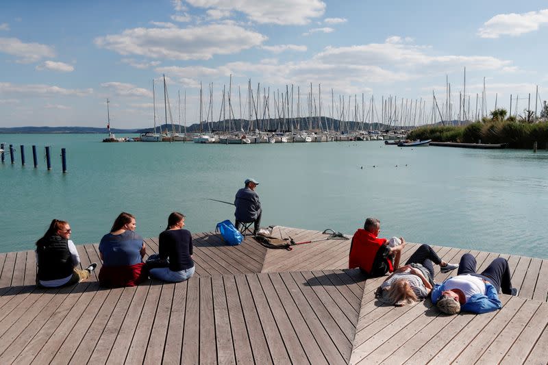 People enjoy the sun on the shore of Lake Balaton, following the outbreak of the coronavirus disease (COVID-19), in Balatonfured