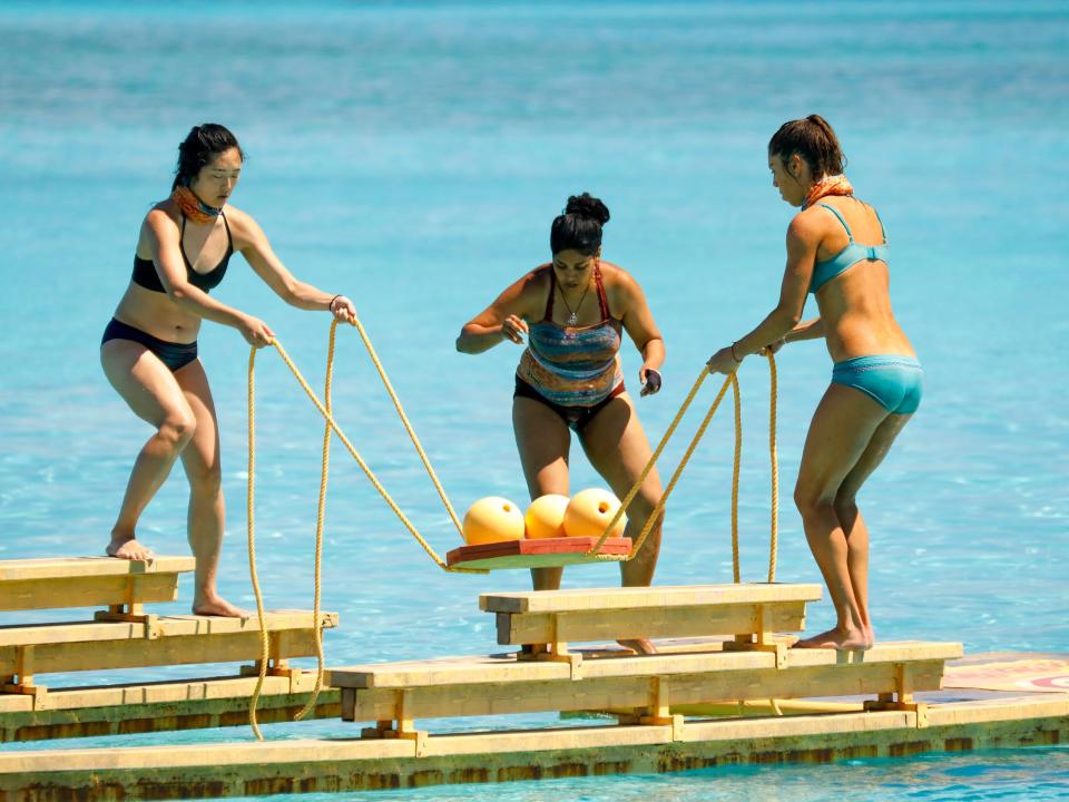 Kellee Kim, Karishma Patel, and Noura Salman competing in a challenge in the water