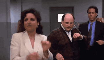 Elaine, George, and Jerry dancing in "Seinfeld"