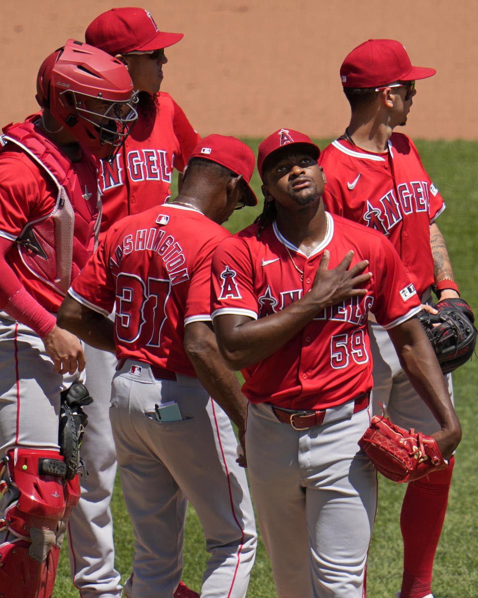 Los Angeles Angels starting pitcher José Soriano (59) walks off the mound after handing the ball to manager Ron Washington (37) during the fifth inning of a baseball game against the Pittsburgh Pirates in Pittsburgh, Wednesday, May 8, 2024. (AP Photo/Gene J. Puskar)