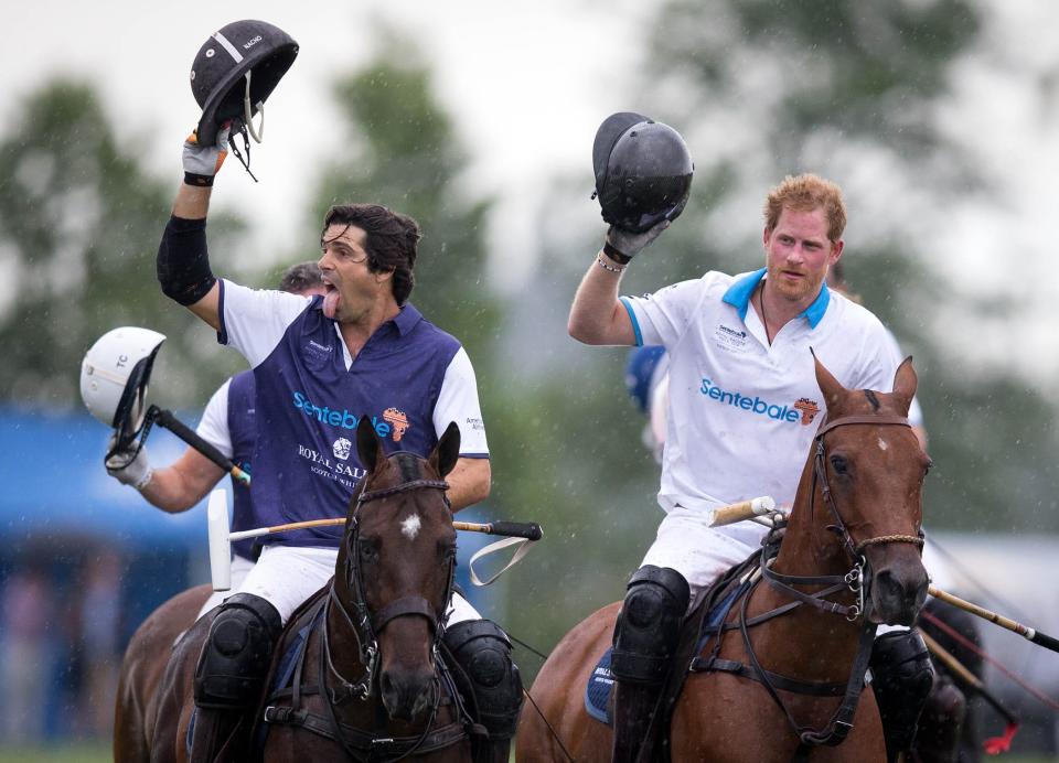 Nacho Figueras and Prince Harry acknowledge the crowd after competing in a charity polo match in Wellington on May 4, 2016.