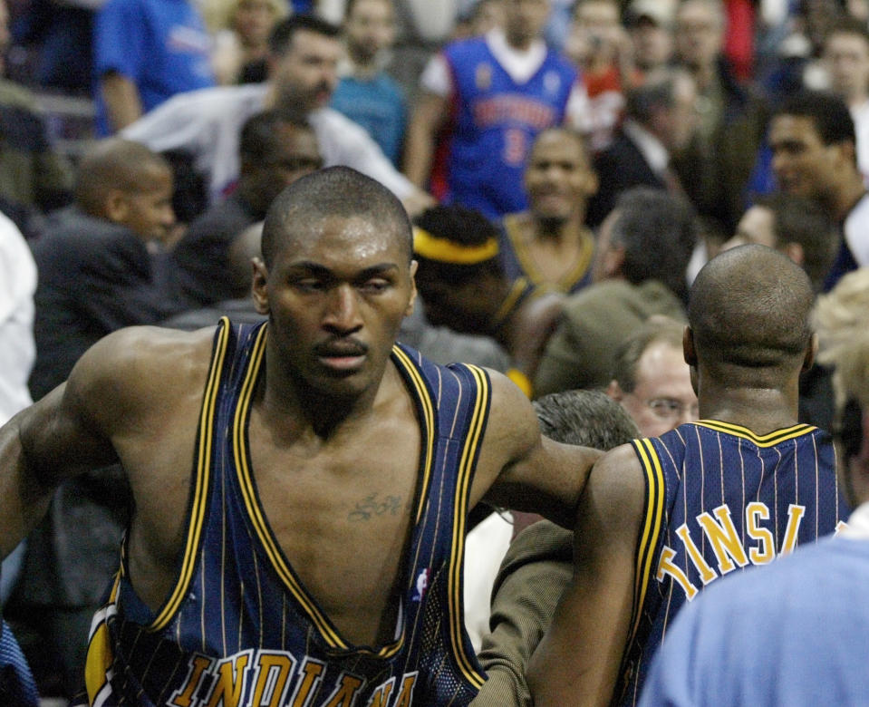 Pacers forward Ron Artest returns to the court after going into the stands to confront fans during a brawl with the Pistons on Nov. 19, 2004, in Auburn Hills, Mich. (AP Photo/Duane Burleson)