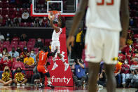 Maryland guard Hakim Hart, center, drops a dunk in front of Illinois Fighting guard Trent Frazier (1) during the first half of an NCAA college basketball game, Friday, Jan. 21, 2022, in College Park, Md. (AP Photo/Julio Cortez)