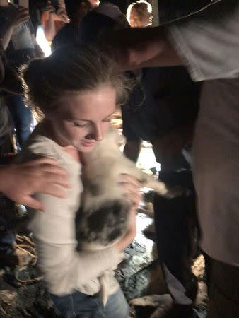 Puppy is being lifted out of a hole and reunited with its fosterer in Huntsville, Alabama, U.S., June 30, 2018 in this picture grab obtained from social media video. Instagram/Katie Ziegler/via REUTERS