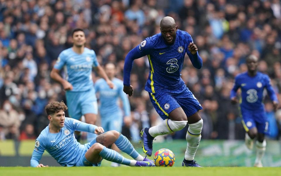 Chelsea's Romelu Lukaku (right) skips away from Manchester City's John Stones during the Premier League match at Etihad Stadium, - Martin Rickett/PA Wire