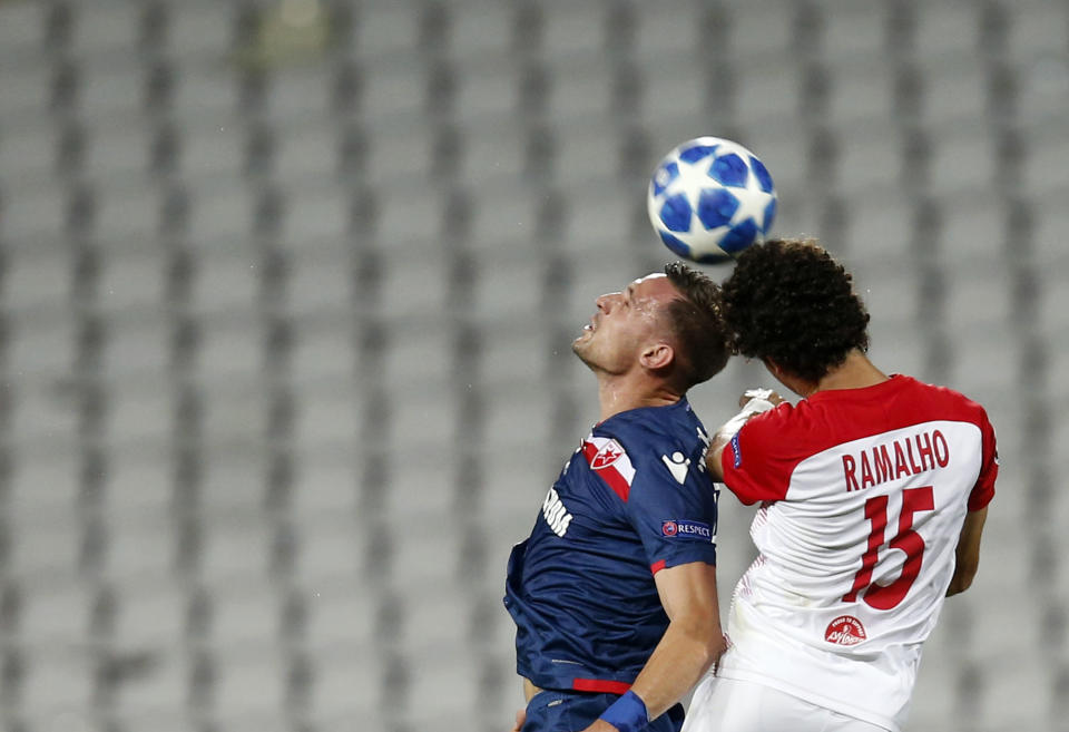 Red Star's Nikola Stoiljkovic, left, jumps for the ball with Salzburg's Andre Ramalho during the Champions League qualifying play-off first leg soccer match between Red Star and Salzburg on the stadium Rajko Mitic in Belgrade, Serbia, Tuesday, Aug. 21, 2018. (AP Photo/Darko Vojinovic)