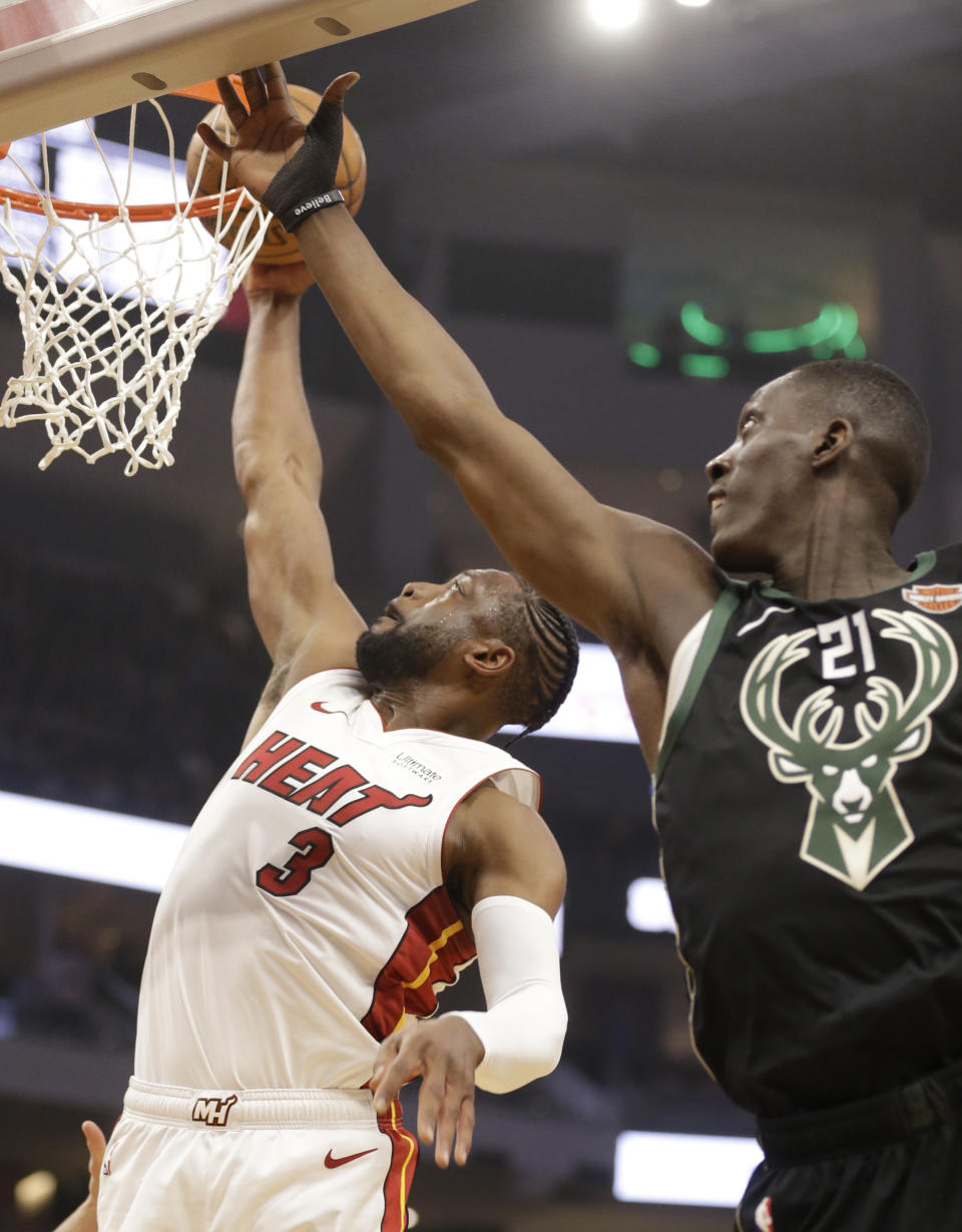 Miami Heat's Dwyane Wade (3) dunks the ball against Milwaukee Bucks' Tony Snell during the first half of an NBA basketball game Friday, March 22, 2019, in Milwaukee. (AP Photo/Jeffrey Phelps)