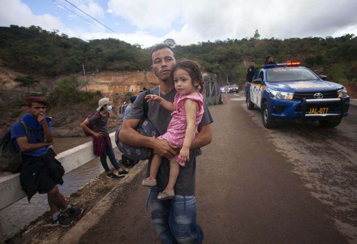 <span class="caption">Migrants hoping to reach the distant U.S. border walk along a highway in Guatemala in January 2021.</span> <span class="attribution"><a class="link " href="https://newsroom.ap.org/detail/GuatemalaMigrants/954865c26bcf44a88f139779e5e5f008/photo" rel="nofollow noopener" target="_blank" data-ylk="slk:AP Photo/Sandra Sebastian;elm:context_link;itc:0;sec:content-canvas">AP Photo/Sandra Sebastian</a></span>