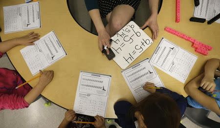 FILE PHOTO: Teacher Jenna Rosenberg speaks to her first grade class at Walsh Elementary School in Chicago, Illinois, March 1, 2013. REUTERS/Jim Young