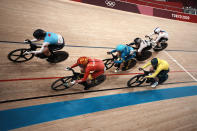 Kelsey Mitchell of Team Canada (105) and Liubov Basova of Team Ukraine (228) compete during the track cycling women keirin at the 2020 Summer Olympics, Thursday, Aug. 5, 2021, in Izu, Japan. (AP Photo/Thibault Camus)