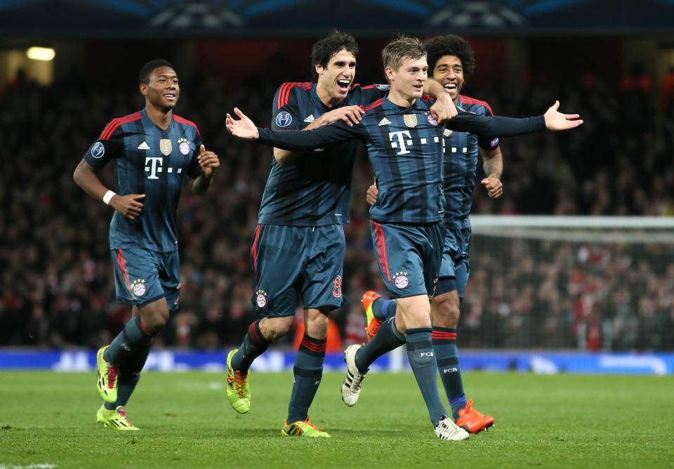 Munich's Toni Kroos, front celebrates his side's opening goal with David Alaba, Javier Martinez and Dante, from left, during a Champions League, round of 16, first leg soccer match between Arsenal and Bayern Munich at the Emirates stadium in London, Wednesday, Feb. 19, 2014 .(AP Photo/Alastair Grant)