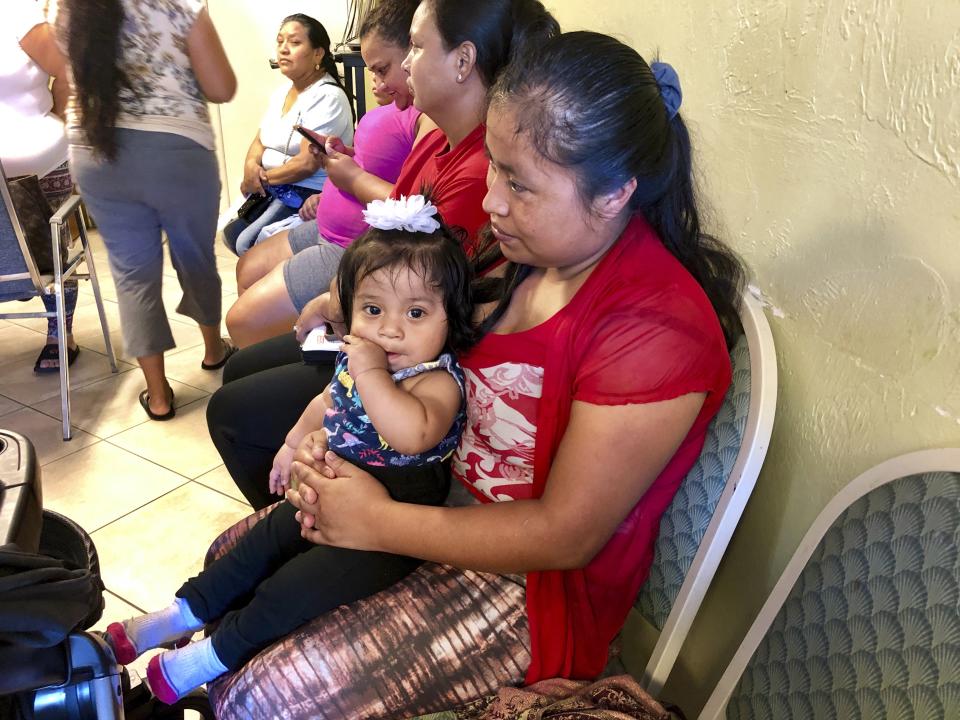 Amalia Godinez sits her 10-month-old daughter Priscila on her lap as she waits for help at the Guatemalan-Maya Center on Friday, Aug. 30, 2019 in Lake Worth, Fla. Godinez said she was worried she would lose power and not be able to cook for her three children. Charity groups are worried about vulnerable populations along the eastern coast, who were still in the cone of potential storm pathway forecast by the National Hurricane Center in Miami. (AP PhotoAdriana Gomez)