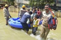 Firefighters help evacuate residents from a flooded area after heavy rainfall in Bangalore, India, Monday, Sept. 5, 2022. Life for many in the southern Indian city of Bengaluru was disrupted on Tuesday after two days of torrential rains set off long traffic snarls, widespread power cuts and heavy floods that swept into homes and submerged roads. (AP Photo/Kashif Masood)