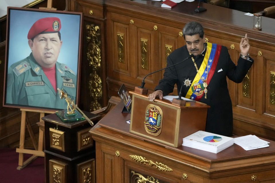 FILE - Standing next to a portrait of late President Hugo Chavez, Venezuelan President Nicolas Maduro delivers his annual address to the nation before lawmakers at the National Assembly in Caracas, Venezuela, Thursday, Jan. 12, 2023. The Immigration and Nationality Act of 1952 lets the president grant entry for humanitarian reasons and matters of public interest. Previous administrations have admitted large numbers of Hungarians, Vietnamese and Cubans. (AP Photo/Ariana Cubillos, File)