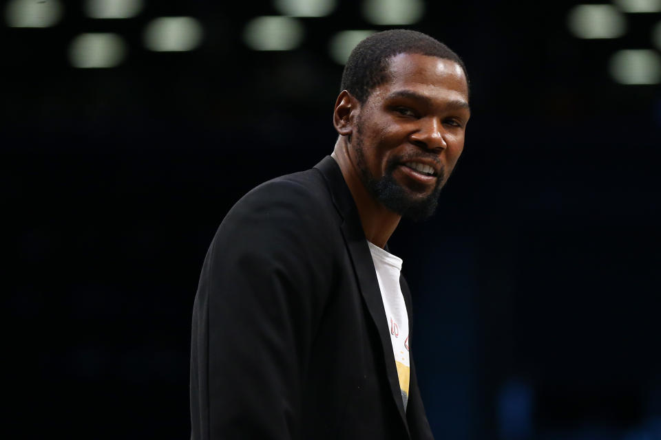 NEW YORK, NEW YORK - FEBRUARY 03: Kevin Durant  #7 of the Brooklyn Nets looks on from the bench during the game Phoenix Suns at Barclays Center on February 03, 2020 in New York City.Brooklyn Nets defeated the Phoenix Suns 119-97. NOTE TO USER: User expressly acknowledges and agrees that, by downloading and or using this photograph, User is consenting to the terms and conditions of the Getty Images License Agreement. (Photo by Mike Stobe/Getty Images)