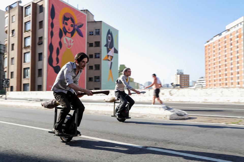 Friends Vinicius Sanctus and Alessandro Russo ride electric monowheels called 'nuvem' (cloud) that were invented by them and inspired by the magic flying brooms of the Harry Potter series in Sao Paulo, Brazil November 7, 2020. Picture taken November 7, 2020. REUTERS/Amanda Perobelli