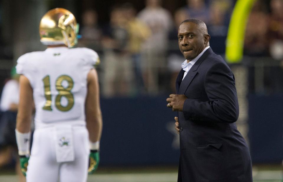 Tim Brown walks off the field after the coin toss during the Shamrock Series game between Notre Dame and Arizona State on Saturday, Oct. 5, 2013, at AT&T Stadium in Arlington, Texas.
