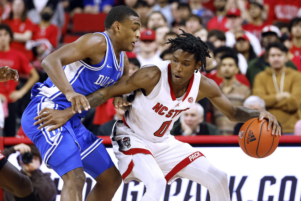 North Carolina State's Terquavion Smith (0) controls the ball as Duke's Jeremy Roach defends during the second half of an NCAA college basketball game in Raleigh, N.C., Wednesday, Jan. 4, 2023. (AP Photo/Karl B DeBlaker)