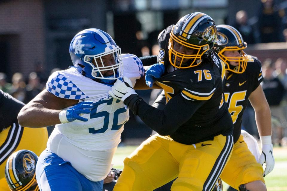Kentucky defensive lineman Justin Rogers, left, fights his way past Missouri's Javon Foster, right, during the fourth quarter of an NCAA college football game Saturday, Nov. 5, 2022, in Columbia, Mo. (AP Photo/L.G. Patterson)