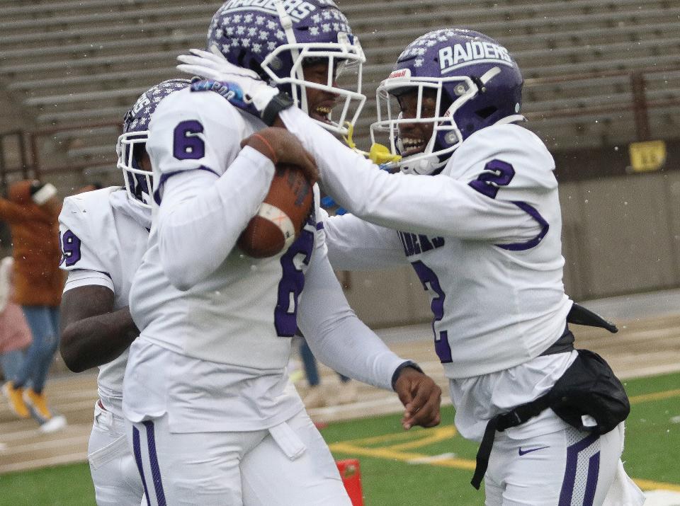 Mount Union's Wayne Ruby Jr., left, and Orreon Finley (2) celebrate after Ruby's game-winning catch during action at Baldwin Wallace Saturday, November 12, 2022.