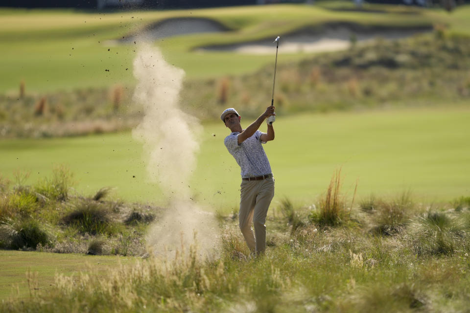 Jackson Suber hits from the native area on the 14th hole during the first round of the U.S. Open golf tournament Thursday, June 13, 2024, in Pinehurst, N.C. (AP Photo/Matt York)