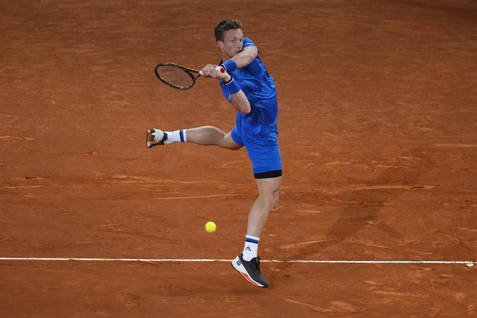 Jiri Lehecka, of Czech Republic, returns the ball to Rafael Nadal of Spain, during the Mutua Madrid Open tennis tournament in Madrid, Tuesday, April 30, 2024. (AP Photo/Manu Fernandez)