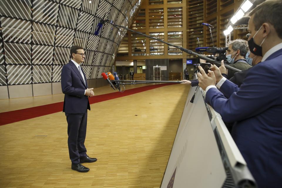 Poland's Prime Minister Mateusz Morawiecki talks to journalists as he arrives for an EU summit in Brussels, Thursday, Oct. 21, 2021. European Union leaders head into a standoff between Poland and most of the other EU member nations over the rule of law in the eastern member state. Other issues for the 27 EU leaders include climate change, the energy crisis, COVID-19 developments and migration. (Olivier Hoslet, Pool Photo via AP)