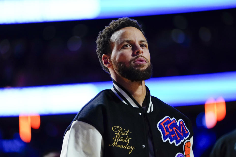 Golden State Warriors' Stephen Curry looks into the stands during the pre-game ceremony of an NBA basketball game against the New York Knicks Tuesday, Dec. 20, 2022, in New York. (AP Photo/Frank Franklin II)