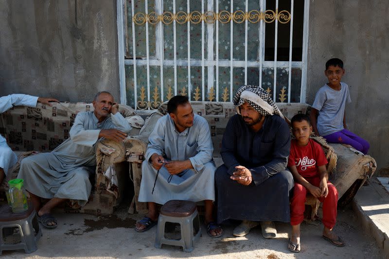 The Wider Image: Drought imperils Iraq's water buffalo and a child's way of life