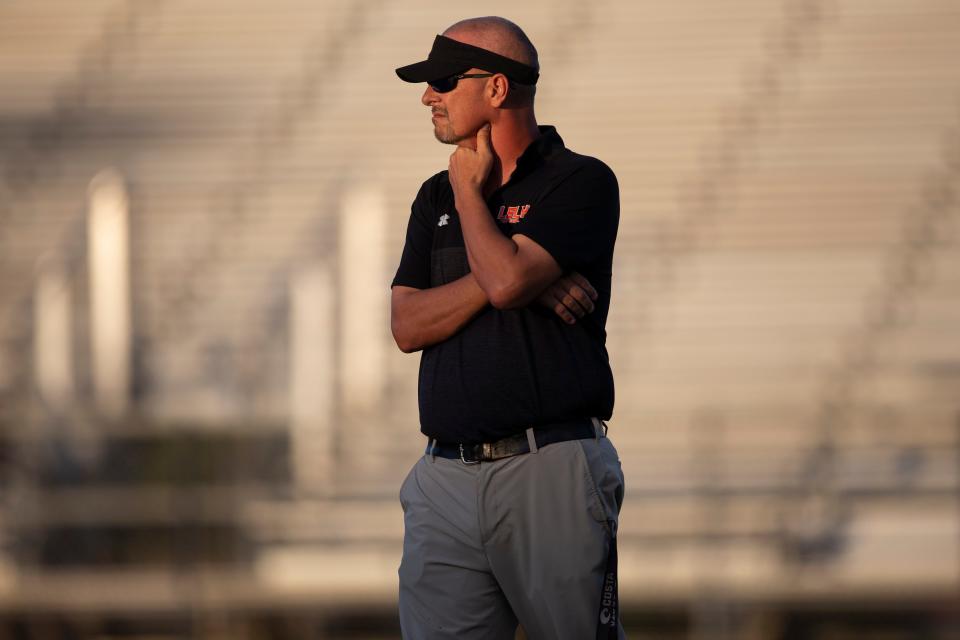 Lely football head coach JJ Everage paces the field before the 48th Coconut Bowl between Naples and Lely, Friday, Oct. 15, 2021, at Lely High School in Naples, Fla.