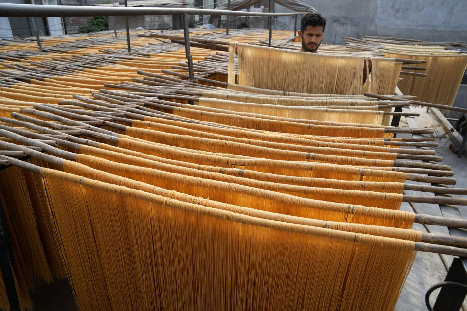 A vendor arranges traditional vermicelli noodles, a favorite during the Muslim's holy fasting month of Ramadan, at a factory, in Lahore, Pakistan, Thursday, March 30, 2023. (AP Photo/K.M. Chaudary)