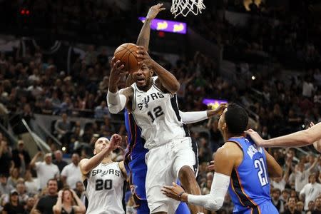 Nov 17, 2017; San Antonio, TX, USA; San Antonio Spurs power forward LaMarcus Aldridge (12) pulls down a rebound in front of Oklahoma City Thunder small forward Paul George (13) during the second half at AT&T Center. Mandatory Credit: Soobum Im-USA TODAY Sports