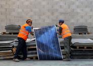 Employees work at Veolia’s solar panel recycling plant in Rousset, France, June 25, 2018. At the plant, photovoltaic panels are dissembled and their constituent parts such as glass, aluminium, silicon and plastics are recycled. REUTERS/Jean-Paul Pelissier