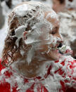 <p>Students from St Andrews University indulge in a tradition of covering themselves with foam to honor the “academic family” on Lower College Lawn on Oct. 23, 2017, in St Andrews, Scotland. (Photo: Jeff J Mitchell/Getty Images) </p>