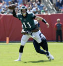 <p>Philadelphia Eagles quarterback Carson Wentz (11) throws a pass as he is grabbed by Tennessee Titans linebacker Jayon Brown in the first half of an NFL football game Sunday, Sept. 30, 2018, in Nashville, Tenn. (AP Photo/Mark Zaleski) </p>