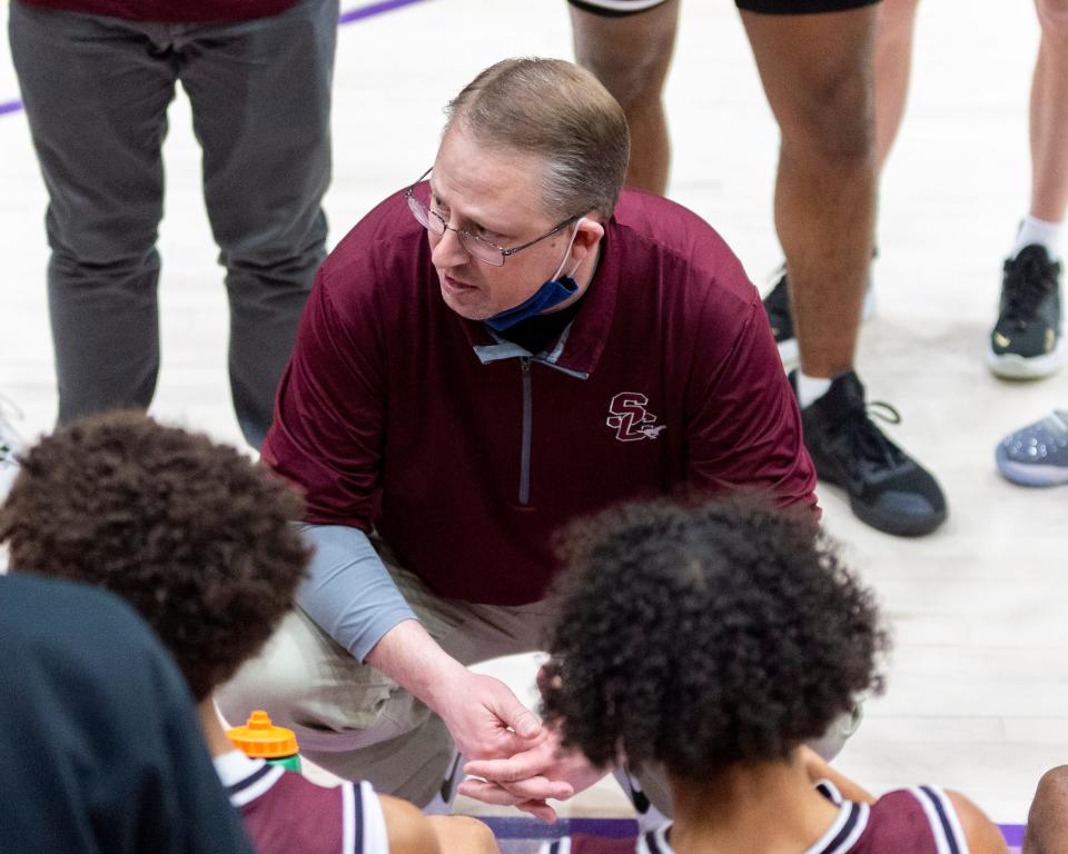 Salina Central coach Ryan Modin talks with his team during the Mustangs' 62-58 loss to Andover in Friday's semifinals of the Salina Invitational Tournament at Mabee Arena.