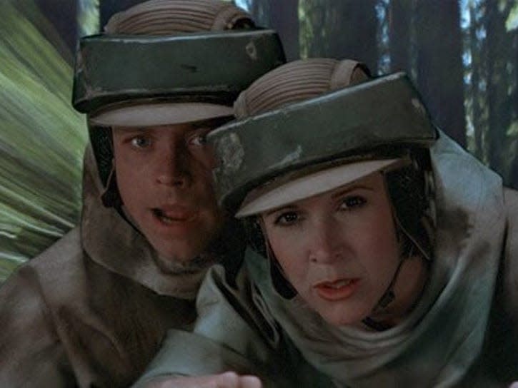 Luke Skywalker (Mark Hamill) and Princess Leia (Carrie Fisher) riding a speeder bike on Endor.