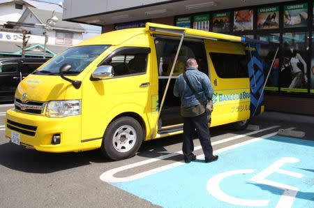 A Banco do Brasil customer waits for his turn at the bank's mobile service van in front of a Brazilian supermarket in Oizumi, Gunma prefecture, Japan April 2, 2017. Picture taken April 2, 2017. REUTERS/Lisa Twaronite