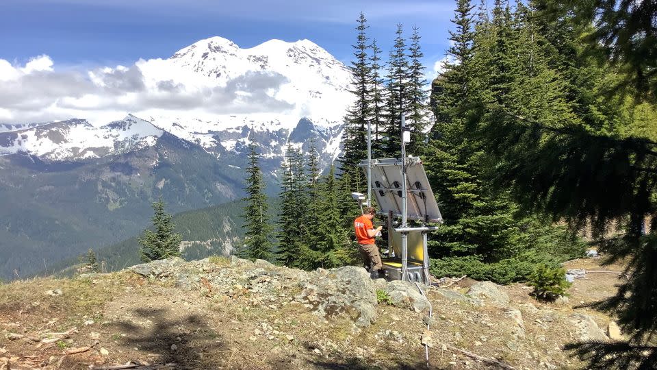 USGS Cascades Volcano Observatory geophysicist Rebecca Kramer works at station PR05, part of the Mount Rainier lahar detection network.  The system has been updated and expanded since it was created in 1998. - Rob Mertens/US Geological Survey Cascades Volcano Observatory