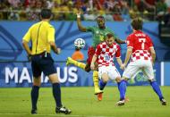 Cameroon's Enoh Eyong (2nd L) fights for the ball with Croatia's Luka Modric (2nd R) and Ivan Rakitic during their 2014 World Cup Group A soccer match at the Amazonia arena in Manaus June 18, 2014. REUTERS/Murad Sezer (BRAZIL - Tags: SOCCER SPORT WORLD CUP)