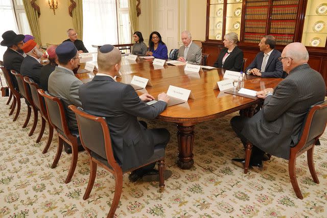 <p>JONATHAN BRADY/POOL/AFP via Getty Images</p> King Charles meets with community faith leaders at Buckingham Palace on March 26, 2024.