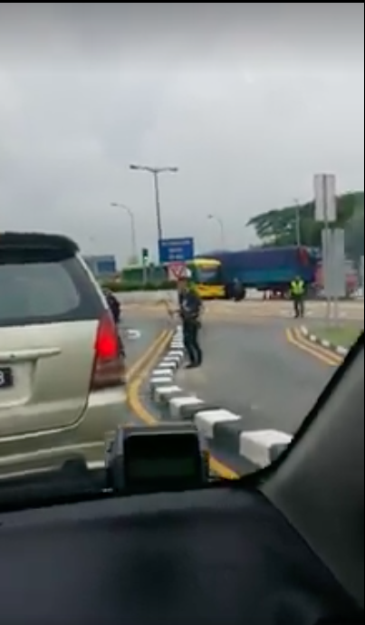 The man at Woodlands Checkpoint appeared to be holding a sharp object. PHOTO: Screengrab from Eric Yau Facebook page