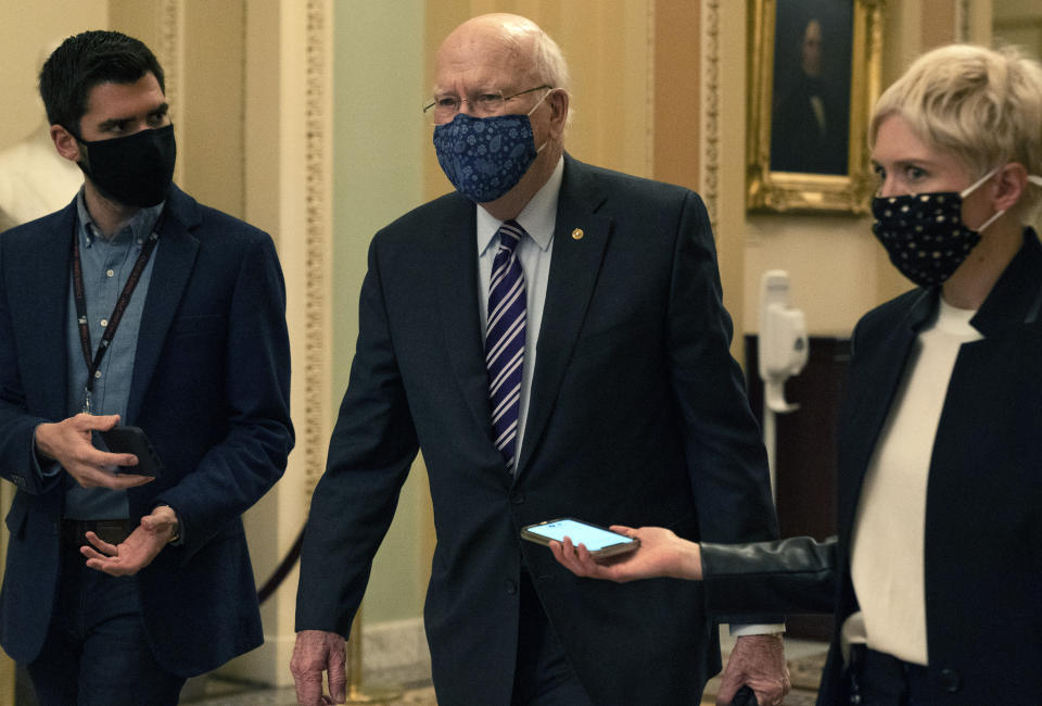 Sen. Patrick Leahy, D-Vt., center, walks with reporters, Tuesday, Jan. 26, 2021, as he leaves the Senate floor on Capitol Hill in Washington. (AP Photo/Jacquelyn Martin)