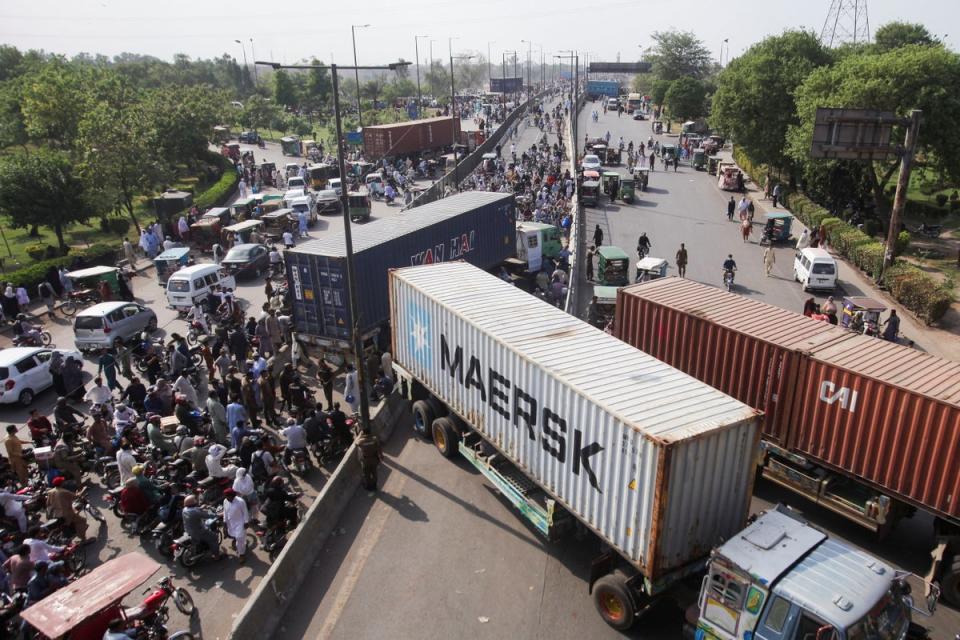 Vehicles with shipping containers to block the roads ahead of the planned protest march on Tuesday (Mohsin Raza/Reuters)