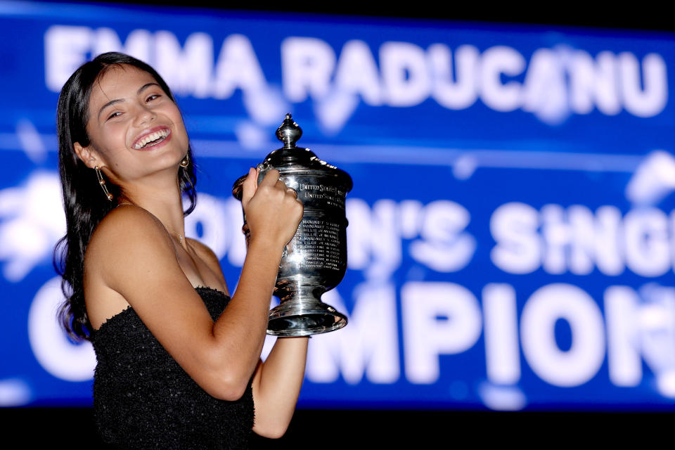 Seen here, Emma Raducanu poses with the trophy after winning the 2021 US Open title.