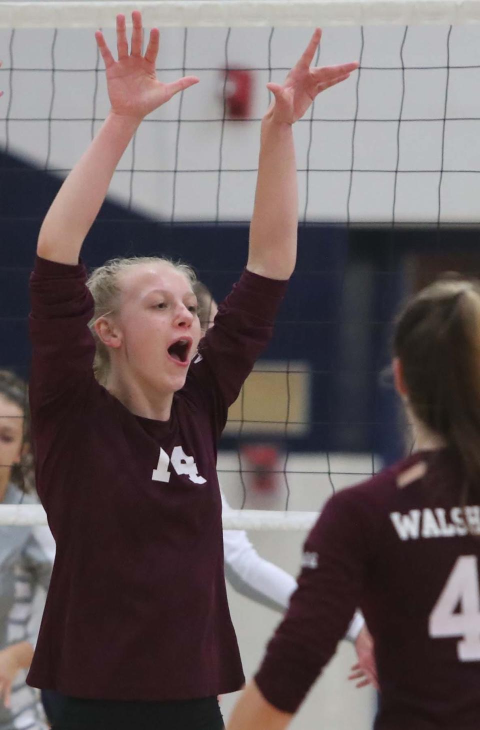 Allison Bedrick of Walsh Jesuit celebrates her point with teammates during the first set of their Division I volleyball district semifinal match at Solon High School in Solon on Tuesday night. 