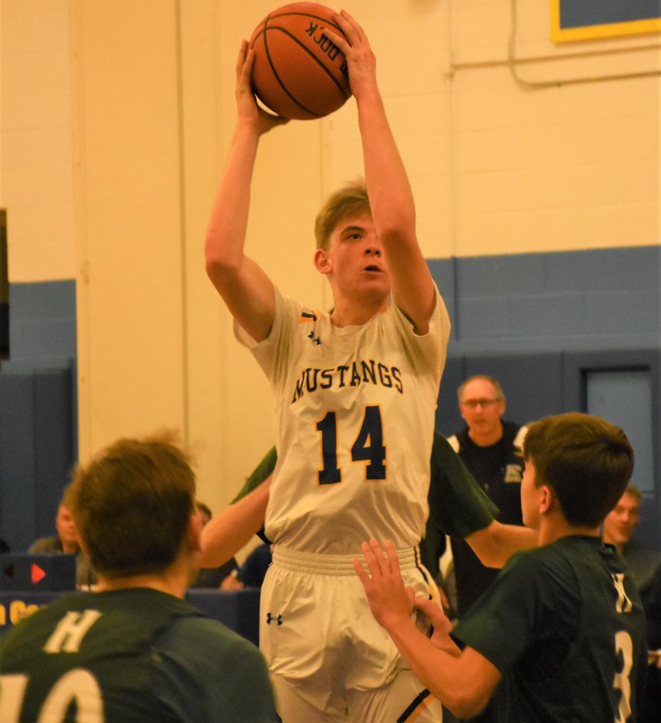 Mt. Markham Mustang Jacob Senko (14) goes up for a shot against the Hamilton Emerald Knights Thursday.